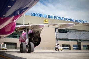 View of Skopje Airport terminal with airplanes and passenger parking area
